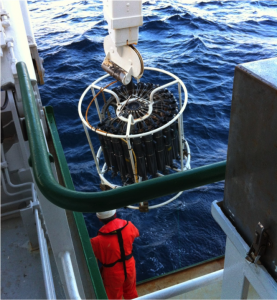 A CTD is deployed over the side of RV Celtic Explorer. The sensors are small and mounted underneath. Visible are the large grey Niskin bottles that can be used to collect water at any depth.
